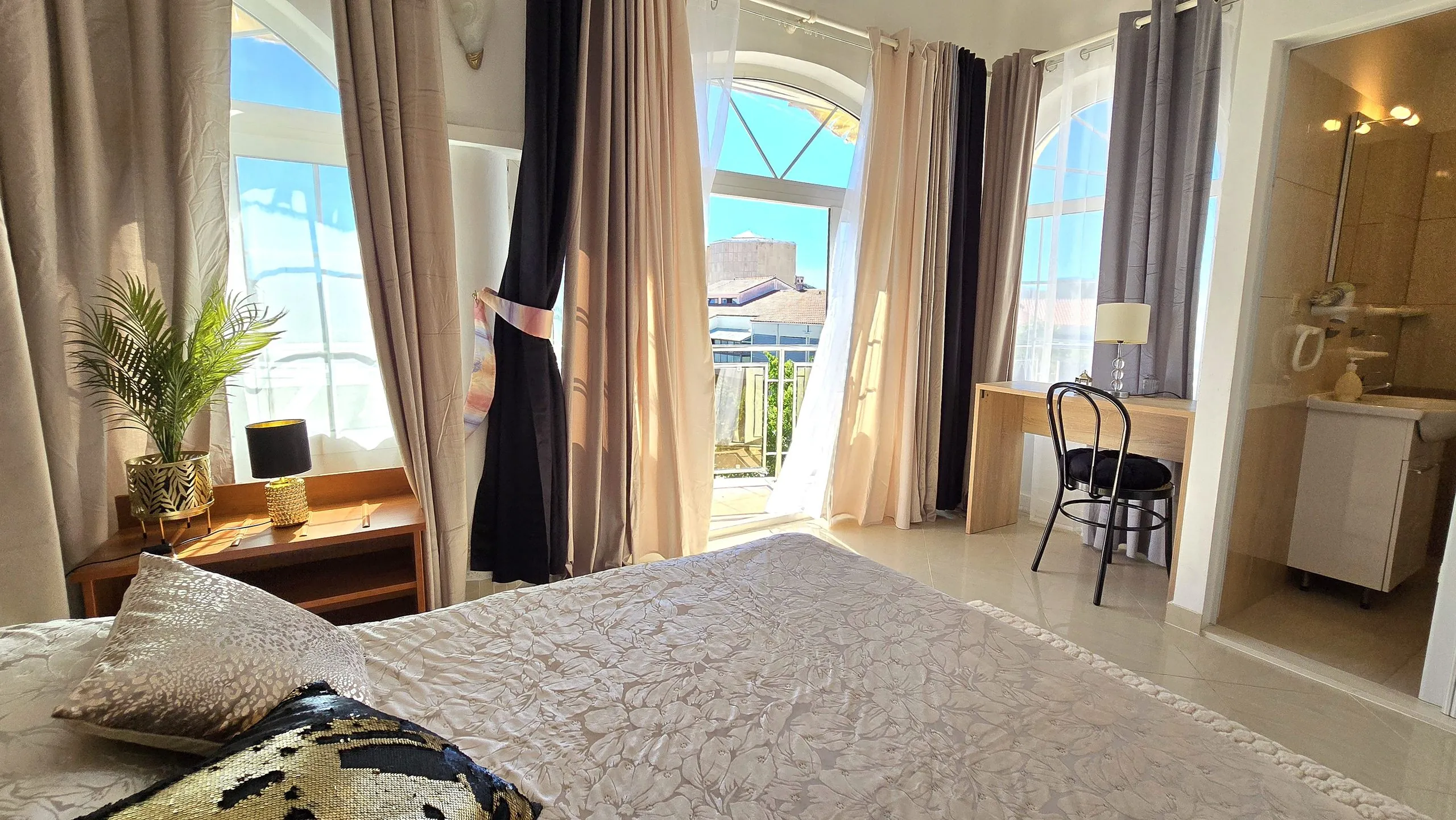 Penthouse bedroom with a desk and terrace access