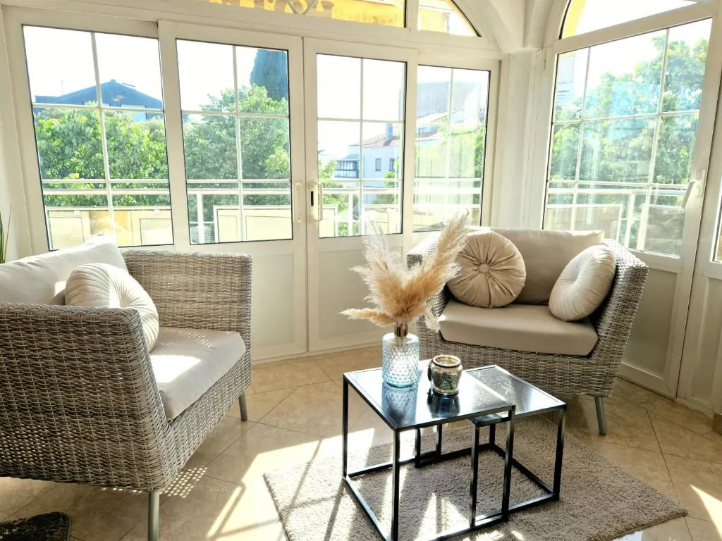 Bright seating corner with wicker armchairs and garden view